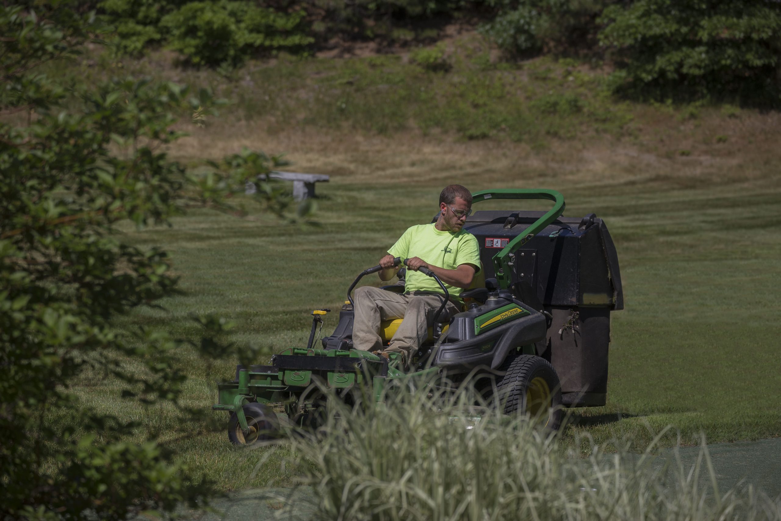 Greenscape employee mowing at Bourne Condos.