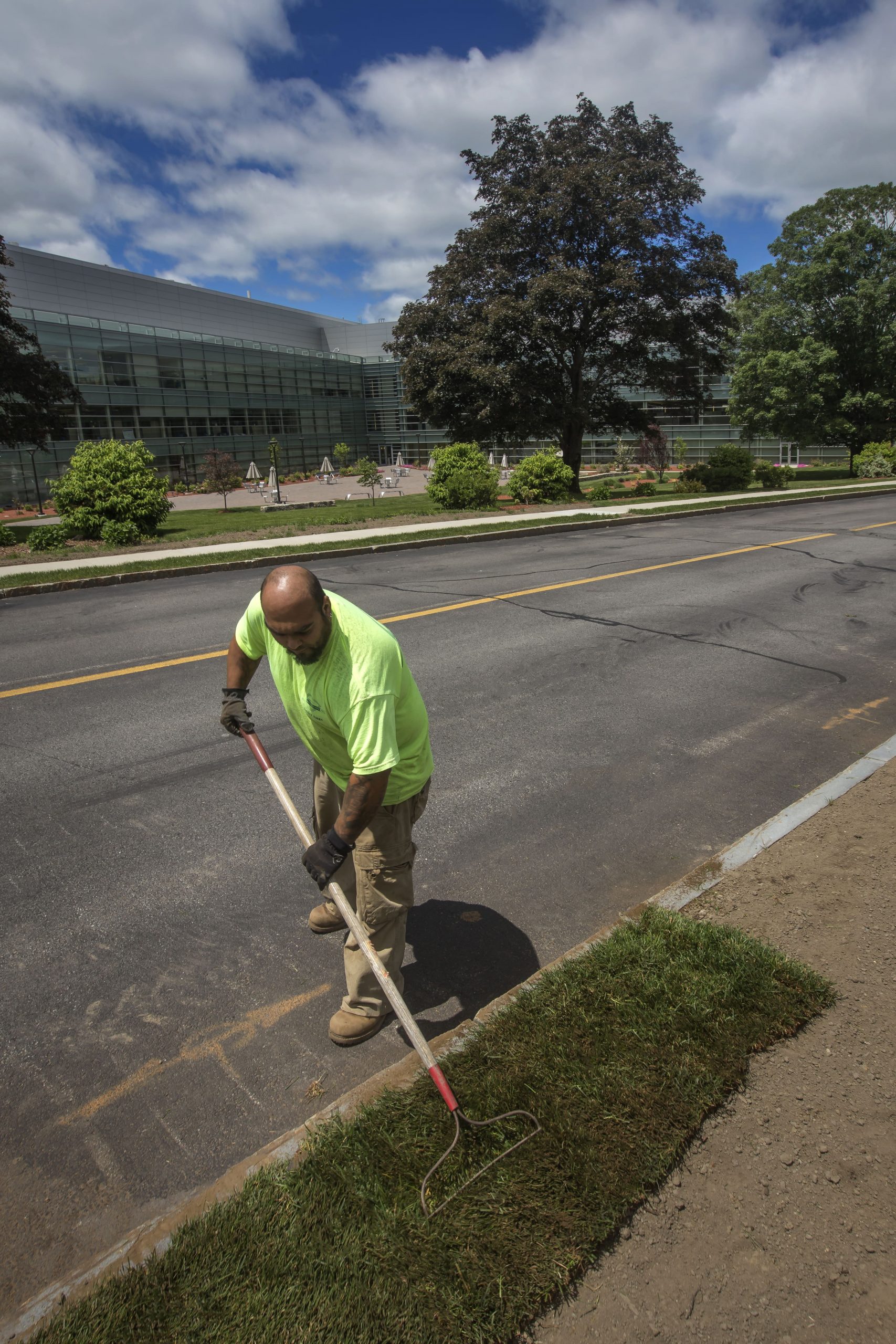 Greenscape employee tending to some freshly laid sod.