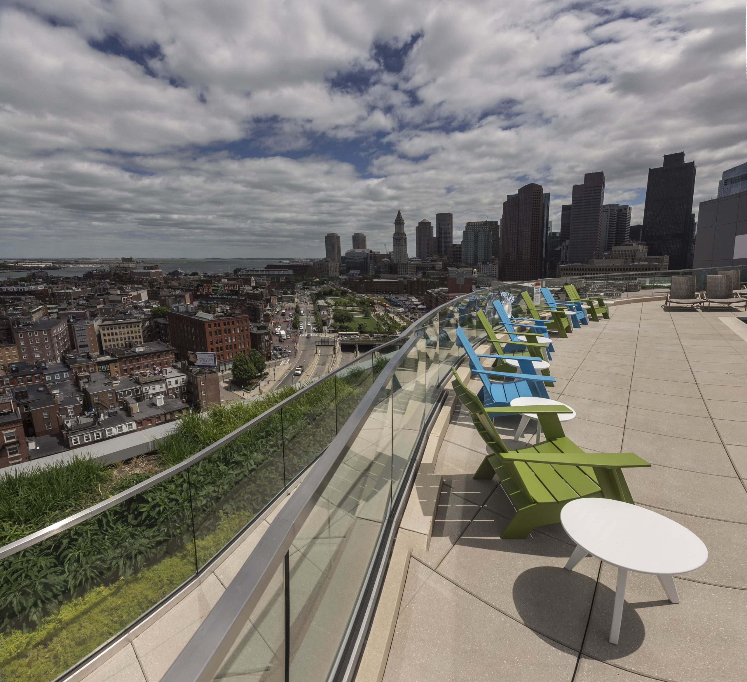 Poolside view of a walkway and garden on a Canal Street terrace.